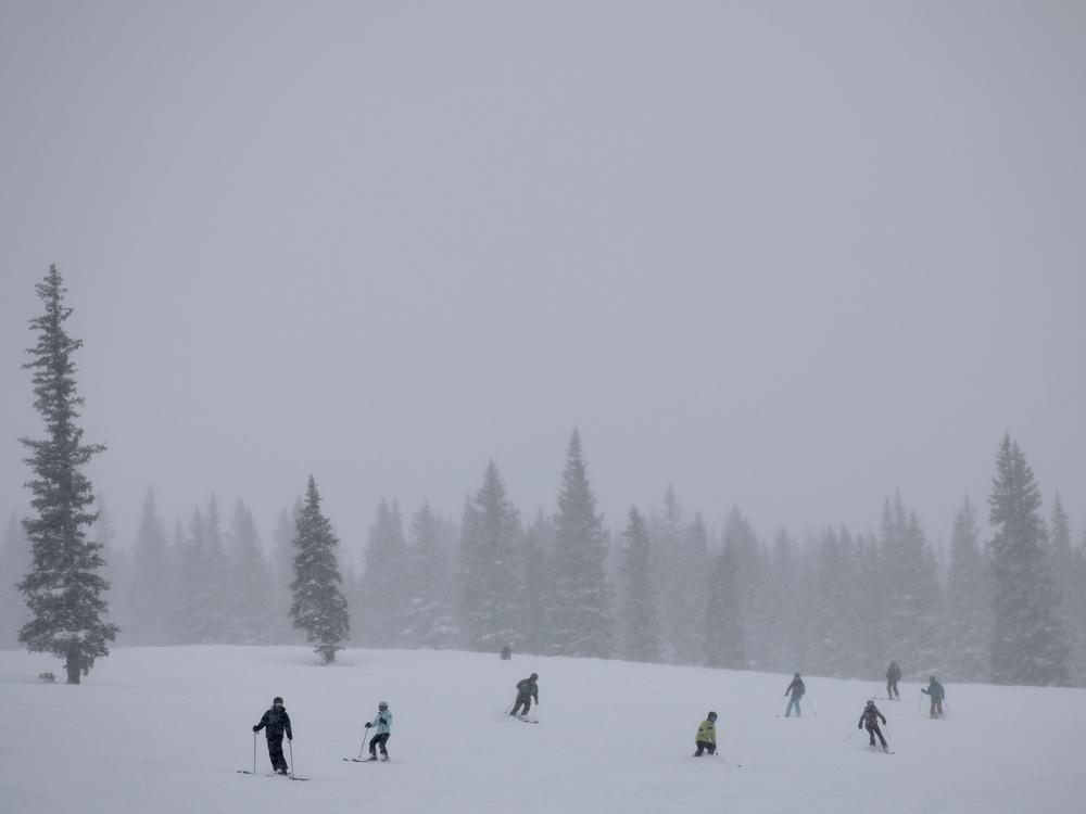 Skiers cruise down the slopes at Snowmass ski area in Colorado. This winter has already delivered snow totals above 130% of average, but climate scientists say it will take more than one wet winter to pull the arid West out of a 23-year drought.