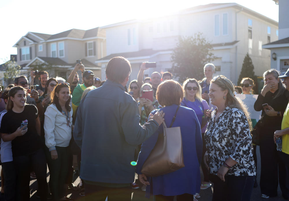 Former President of Brazil Jair Bolsonaro greets and takes photos with supporters outside a home he has been staying at in Kissimmee, Florida, U.S., January 17, 2023.