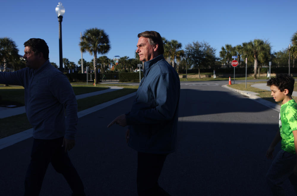 Former President of Brazil Jair Bolsonaro leaves supporters after greeting them and posing for photos with them Jan. 17 outside a home he has been staying at in Kissimmee, Fla.