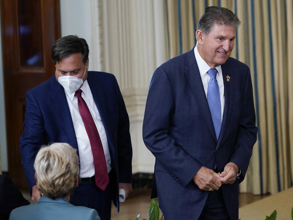 Ron Klain walks with Democratic Sen. Joe Manchin to see President Biden sign the Inflation Reduction Act into law on Aug. 16, 2022.