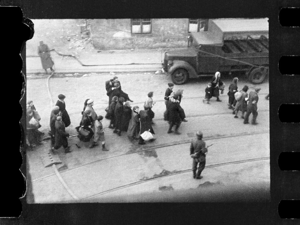 This handout negative dated on April 20, 1943, and taken by Polish firefighter Zbigniew Leszek Grzywaczewski shows Jewish people being evacuated from the Warsaw Ghetto.