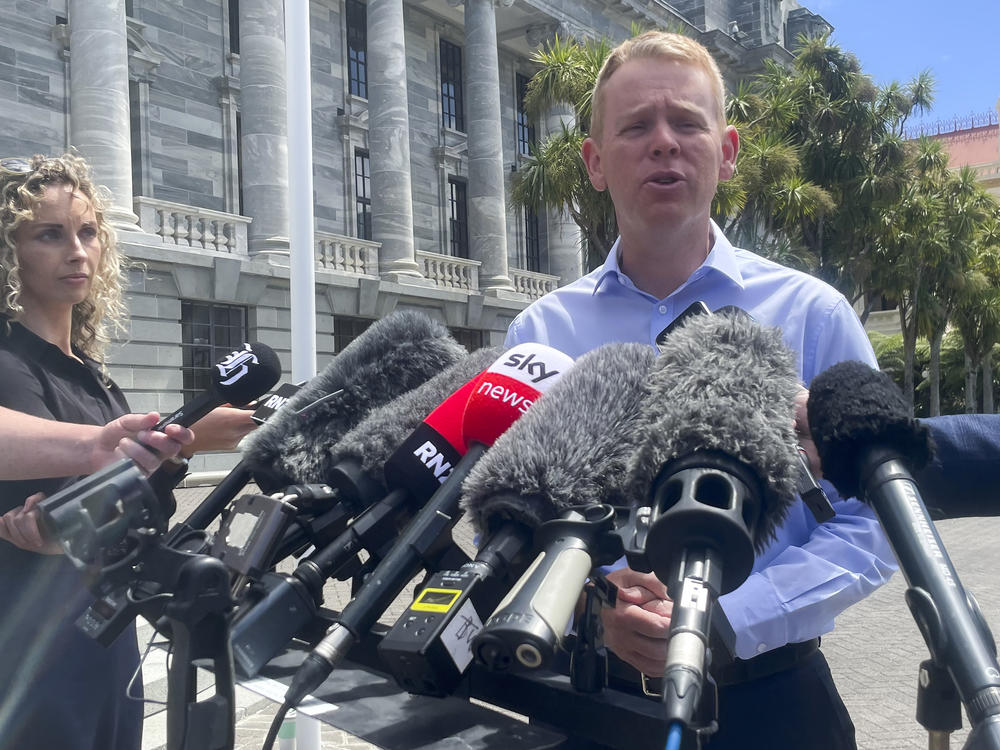 New Zealand Education Minister Chris Hipkins talks to reporters outside Parliament in Wellington, New Zealand, on Saturday.