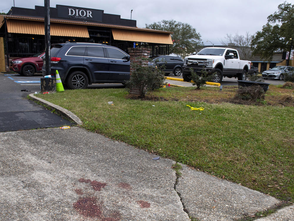 Blood stains and a small section of police tape show the scene where multiple people were injured following an overnight shooting at the Dior Bar & Lounge in Baton Rouge, La., on Sunday, Jan. 22, 2023.