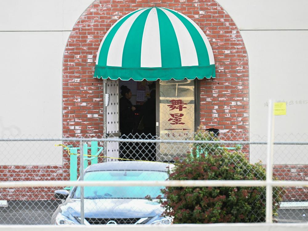 Investigators work at the scene of a mass shooting in Monterey Park, California, on Sunday. A 72-year-old suspect was found dead with a self-inflicted gunshot wound inside a white van in Torrance, Calif.