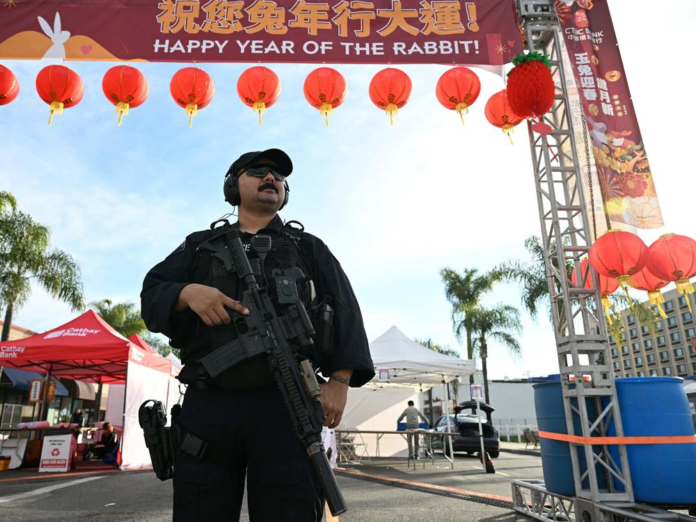Monterey Park police officers stand at the scene of a mass shooting in Monterey Park, California.