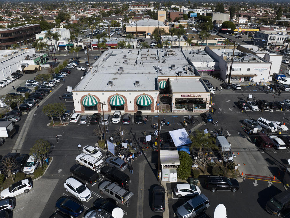 Members of the media are stationed in the parking lot outside Star Ballroom Dance Studio on Jan. 23.