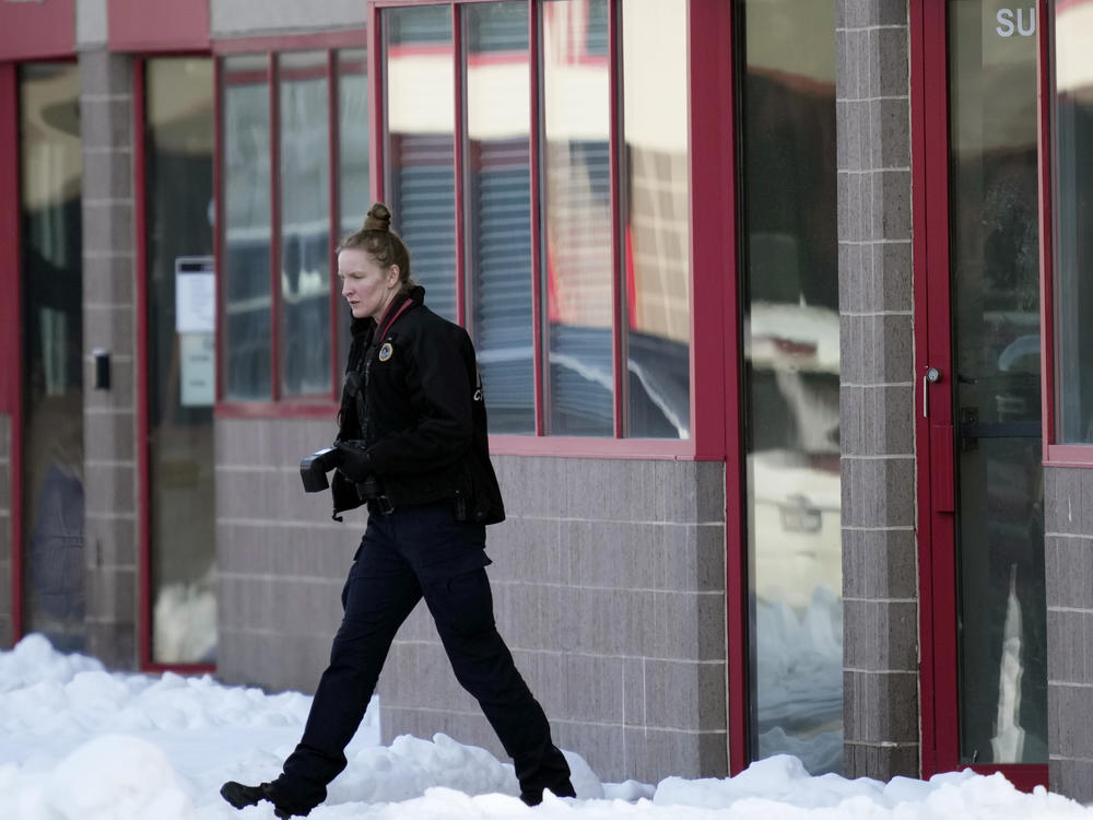 A law enforcement officer exits the Starts Right Here building, Monday, Jan. 23, 2023, in Des Moines, Iowa. Police say two students were killed and a teacher was injured in a shooting at the Des Moines school on the edge of the city's downtown.