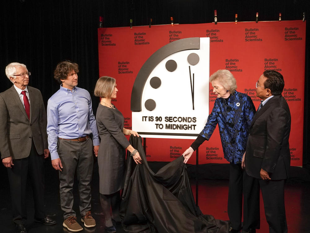 The Bulletin of the Atomic Scientists announced that it has moved the minute hand of the Doomsday Clock to 90 seconds to midnight. From left,, Siegfried Hecker, Daniel Holz, Sharon Squassoni, Mary Robinson and Elbegdorj Tsakhia with the Bulletin of the Atomic Scientists remove a cloth covering the Doomsday Clock at a news conference at the National Press Club in Washington on Tuesday.
