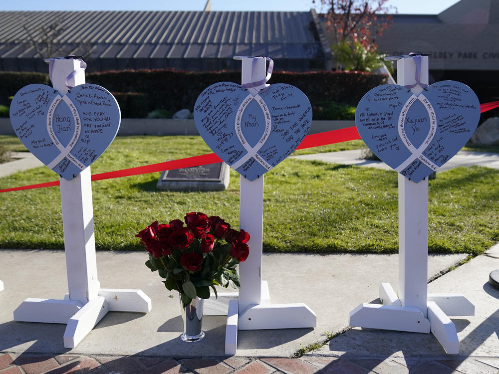 Wooden hearts representing victims stand outside Monterey Park City Hall, blocks from the Star Ballroom Dance Studio, on Jan. 24.