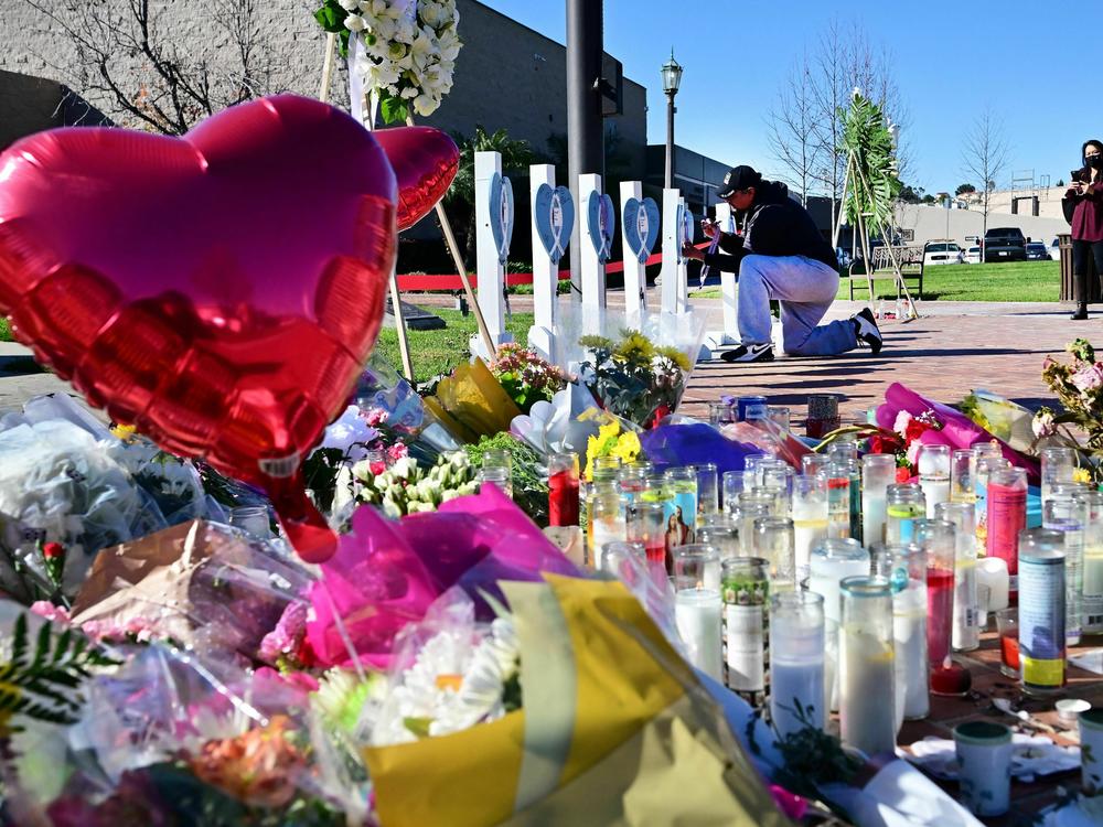 A makeshift memorial of flowers, candles and balloons grows outside City Hall in Monterey Park on Jan. 24.