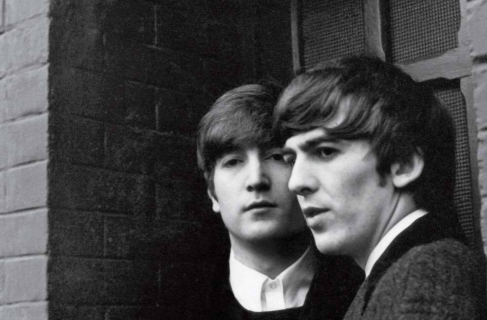 John Lennon and George Harrison, photographed in Paris in 1964.