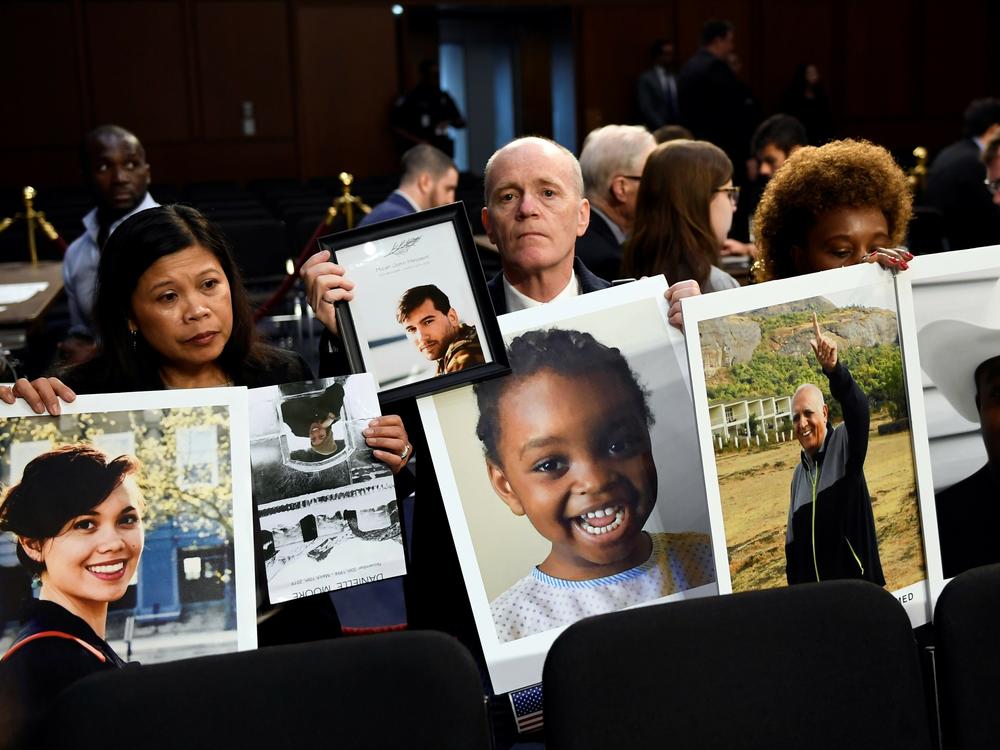 People holding photos of those lost in Ethiopian Airlines Flight 302 and Lion Air Flight 610 wait for the start of a Senate Committee on Commerce, Science, and Transportation hearing on Capitol Hill in Washington, D.C., Tuesday, Oct. 29, 2019, about 
