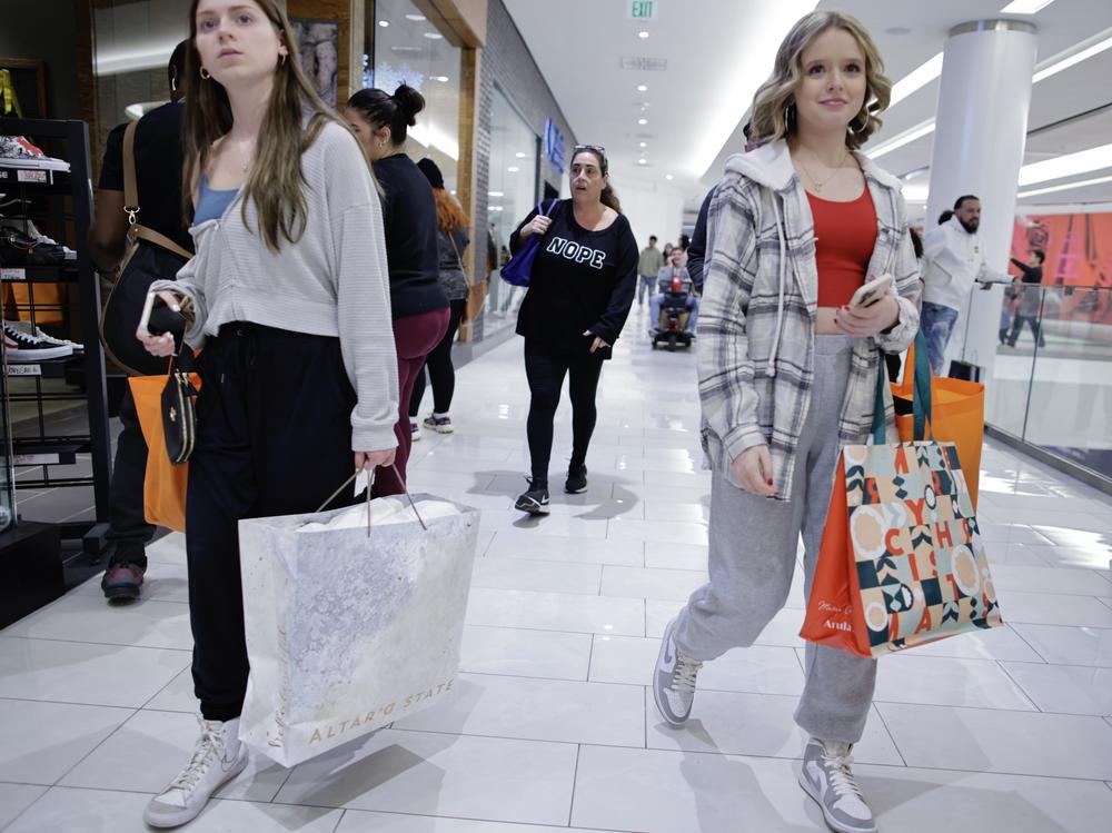 Women carry shopping bags as customers visit the American Mall dream mall during Black Friday on Nov. 25, 2022 in East Rutherford, N.J. The U.S. economy ended 2022 on a strong note, but fears of a recession are growing.