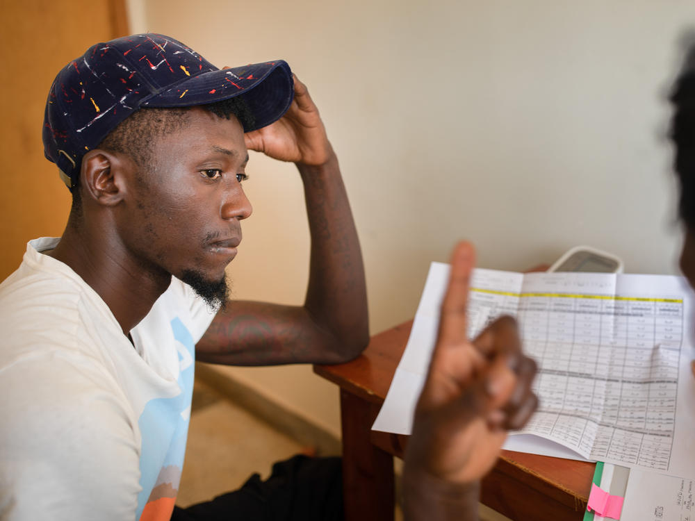 A nurse enrolls a participant in an HIV vaccine trial in Masaka, Uganda, an African-led project.