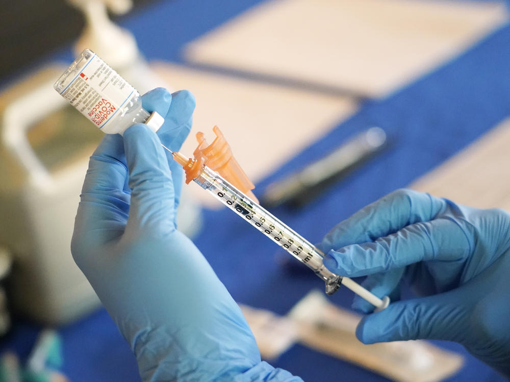 A nurse prepares a syringe of a COVID-19 vaccine at an inoculation station in Jackson, Miss., in 2022. An advisory committee for the FDA voted Thursday to simplify the country's approach to COVID vaccination.