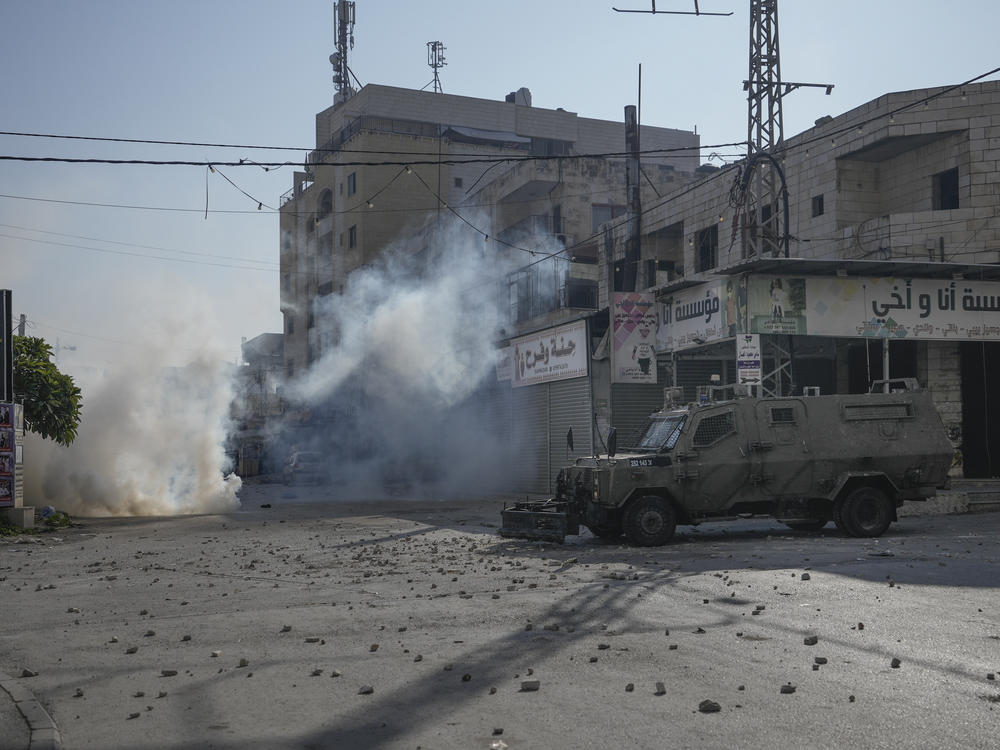Palestinians clash with Israeli forces following an army raid in the West Bank city of Jenin, on Thursday.