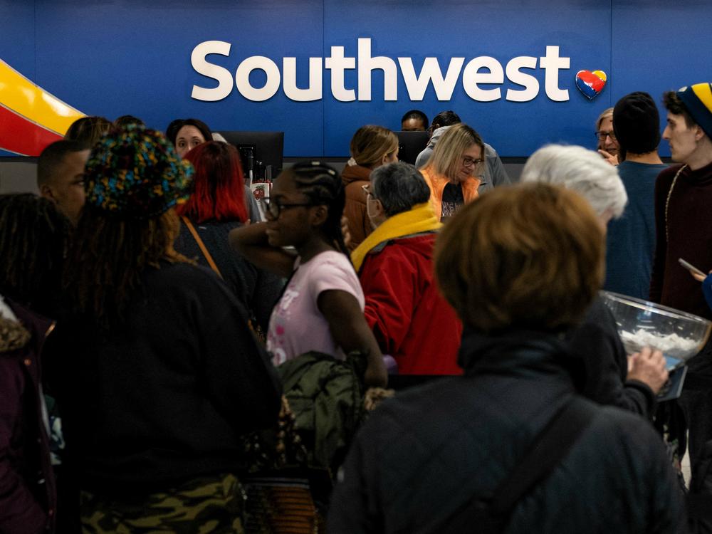 Travelers wait in line at the Southwest Airlines ticketing counter at Nashville International Airport after the airline canceled thousands of flights in Nashville, Tenn., on Dec. 27, 2022. The Department of Transportation is investigating the disaster, which led to $220 million in losses for Southwest