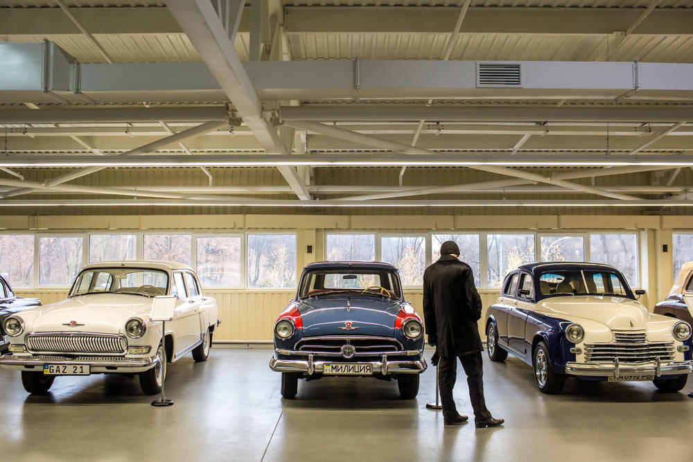 A visitor to a collection of antique cars at Mezhyhirya, the former private estate of former Ukrainian President Viktor Yanukovych, in Novi Petrivtsi, Ukraine. After Yanukovych fled in 2014, the extravagant estate was opened to the public and returned to state ownership.