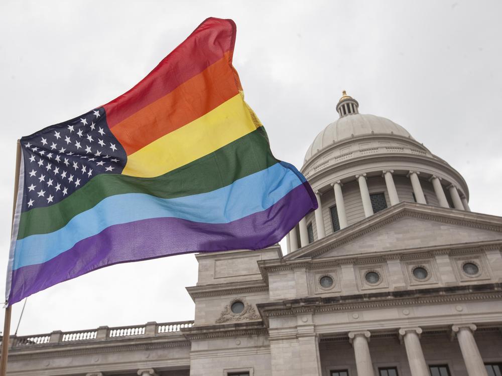 A pride-themed rainbow flag flies over the steps of the Arkansas State Capitol in Little Rock. Until recently, the Arkansas House was considering a bill to restrict where drag shows can be performed.