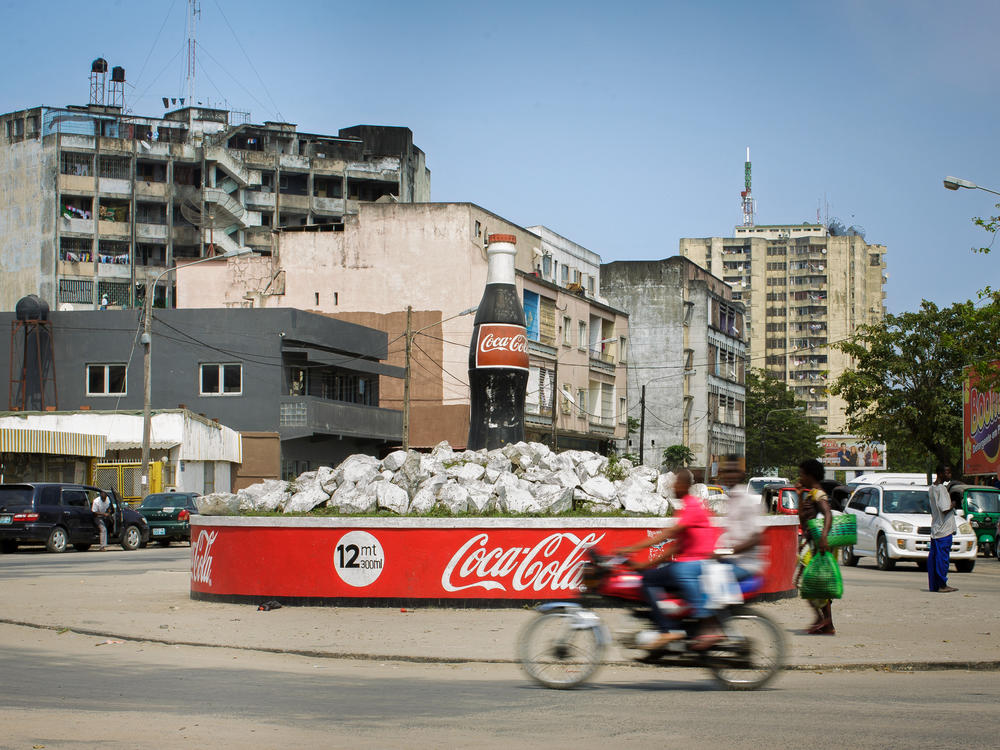 As soda consumption has dropped in the West, companies are making an effort to woo new customers in other places. This Coke bottle ad is in Mozambique.