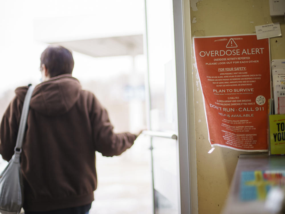 A sign calling attention to drug overdoses is posted in a gas station on the White Earth reservation in Ogema, Minn.. A new study shows that early deaths due to addiction and suicide have impacted American Indian and Alaska Native communities far more than white communities.