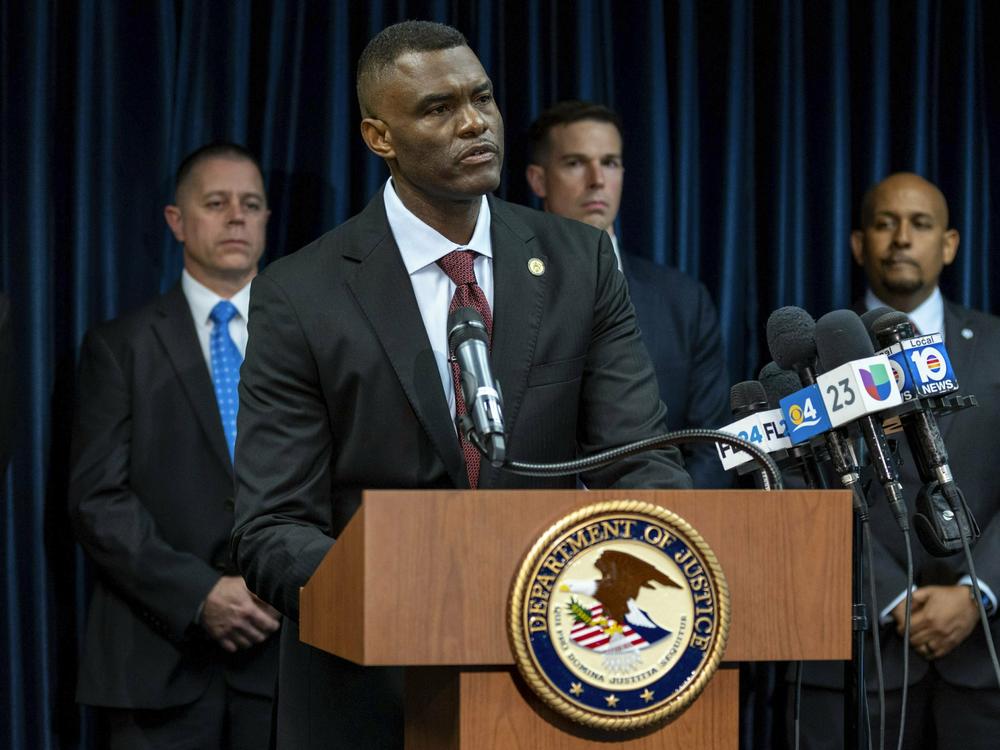 U.S. Attorney Markenzy Lapointe speaks at a news conference in Miami on Wednesday about a network of nursing school operators, centered in South Florida, who allowed students to buy diplomas without the proper training.