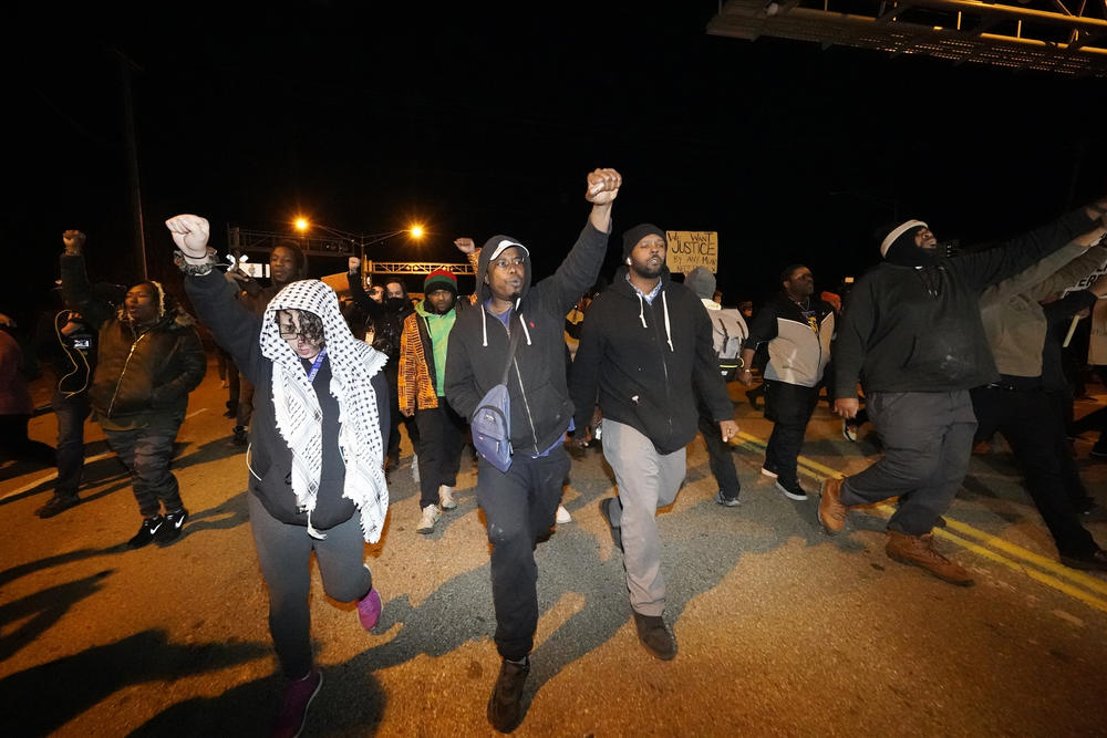 Protesters march on a bridge Friday in Memphis, Tenn., as authorities release police video depicting five Memphis officers beating Tyre Nichols, whose death resulted in murder charges and provoked outrage at the country's latest instance of police brutality.