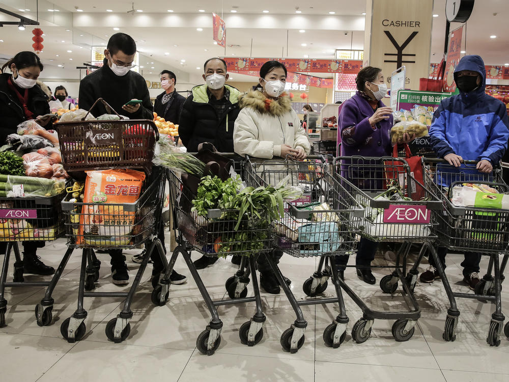 On Jan. 23, 2020, as the coronavirus spread in China, residents of Wuhan, where it was first identified, donned masks to go shopping. The U.S. didn't officially endorse masks as a preventive measure for the public for a number of weeks.