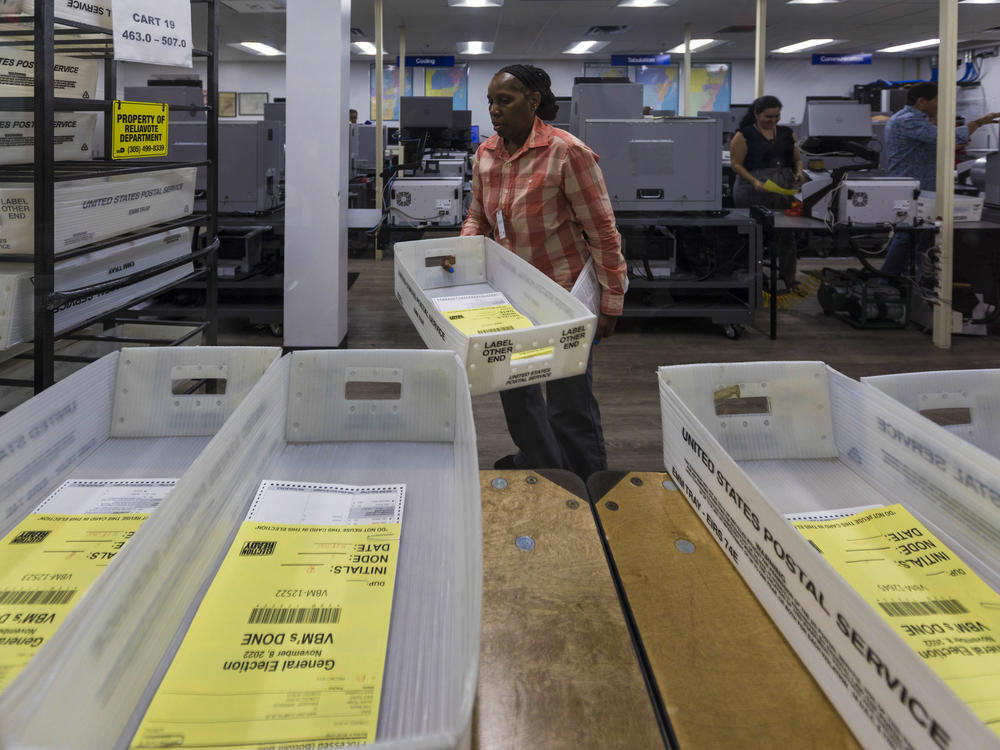 Miami-Dade County elections workers begin counting Florida mail ballots on Nov. 8, 2022.