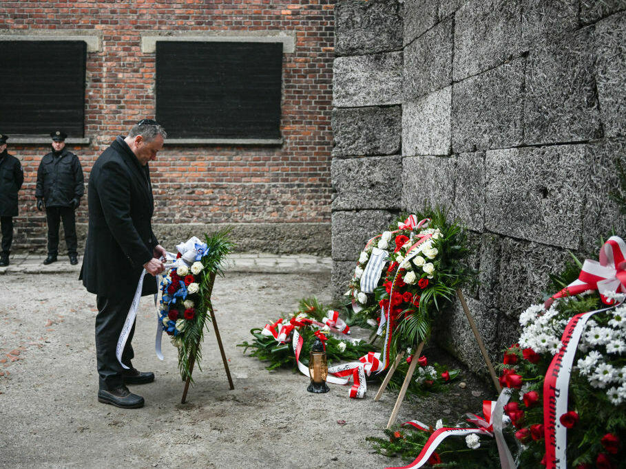 U.S. second gentleman, Doug Emhoff, lays a wreath honoring Holocaust victims at the former Auschwitz site on Friday in Oswiecim, Poland.