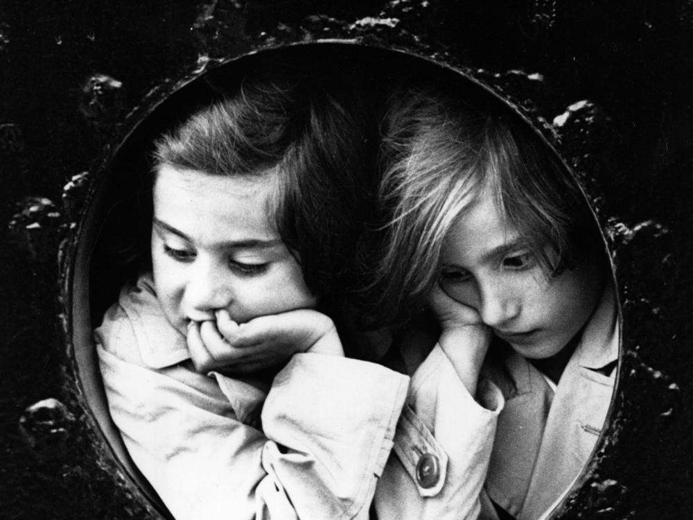 Two young German-Jewish refugees at the porthole of the liner St. Louis finally arrive at Antwerp, after being refused entry to Cuba and Miami prior to the start of World War II.