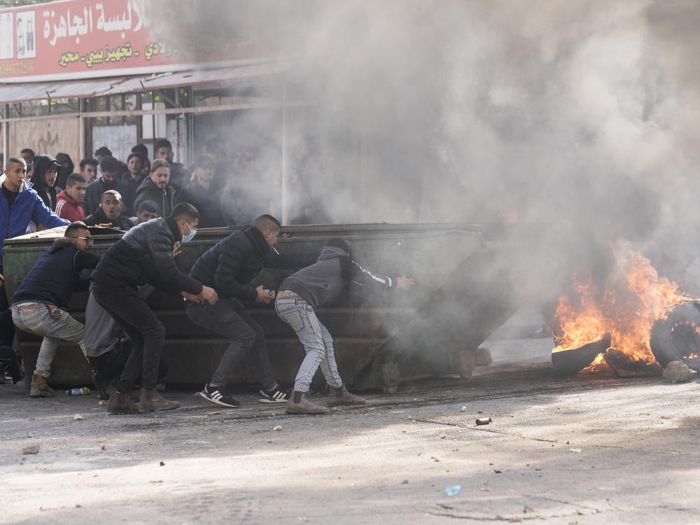 Palestinians clash with Israeli forces following an army raid in the West Bank city of Jenin on Thursday.