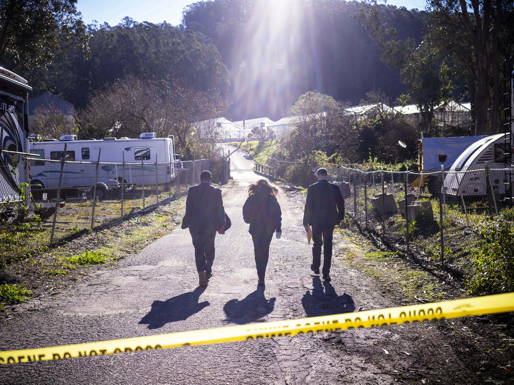 FBI officials walk towards the crime scene at Mountain Mushroom Farm, on Jan. 24, 2023, after a gunman killed several people at two agricultural businesses in Half Moon Bay, Calif.