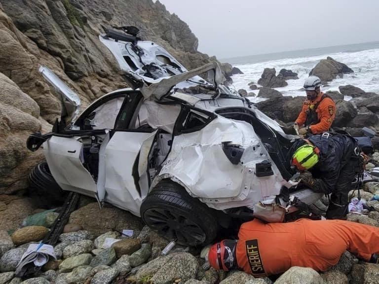 Emergency personnel respond to a vehicle over the side of Highway 1 on Jan. 1, 2023, in California's San Mateo County. The driver who plunged off the treacherous cliff, seriously injuring himself, his wife and their two young children, has been charged with attempted murder.