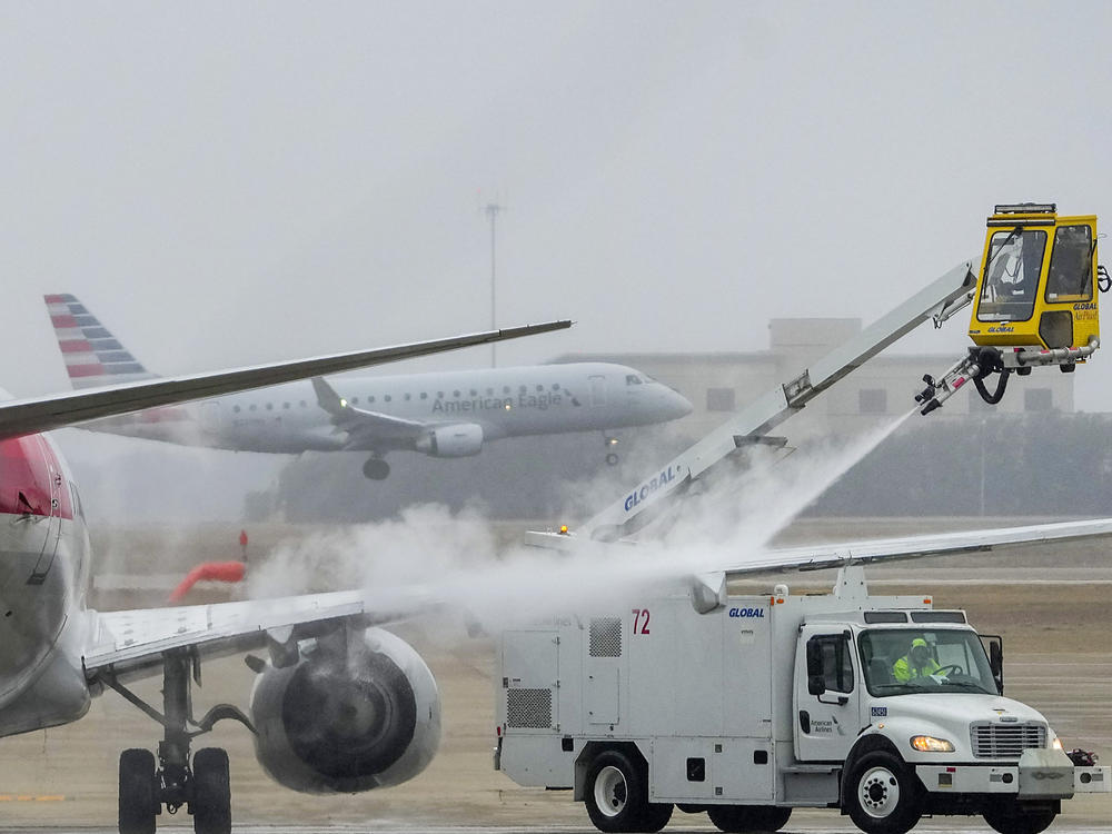 An American Airlines aircraft undergoes deicing procedures on Monday, Jan. 30, 2023, at Dallas/Fort Worth International Airport in Texas.