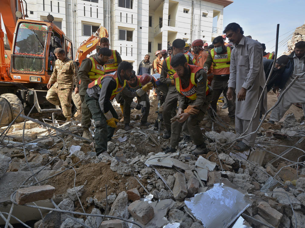 Security officials and rescue workers conduct an operation on Tuesday to clear the rubble and search for bodies at the site of Monday's suicide bombing in Peshawar, Pakistan. The assault on a mosque inside a major police facility was one of the deadliest attacks in Pakistan in recent years.