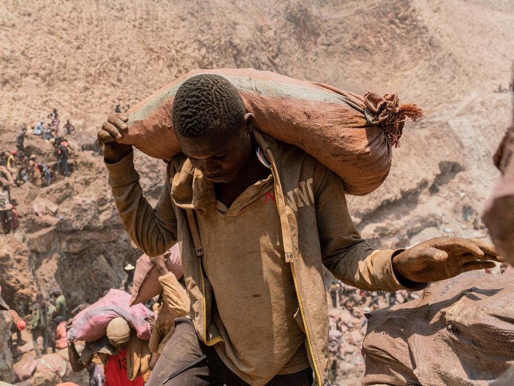 An artisanal miner carries a sack of ore at the Shabara artisanal mine near Kolwezi, DRC, on Oct. 12, 2022.