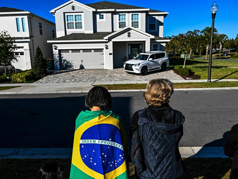 Supporters of Bolsonaro pray for his health outside his rental house at the Encore Resort in Kissimmee, Fla., on Jan. 12.