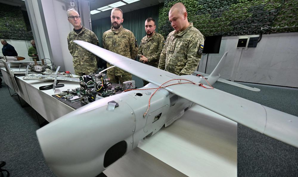 Ukrainian military personnel display a downed Russian drone during a press conference in the capital Kyiv on Dec. 15. Russia has been firing drones and missiles at Ukraine's power systems for the past four months.