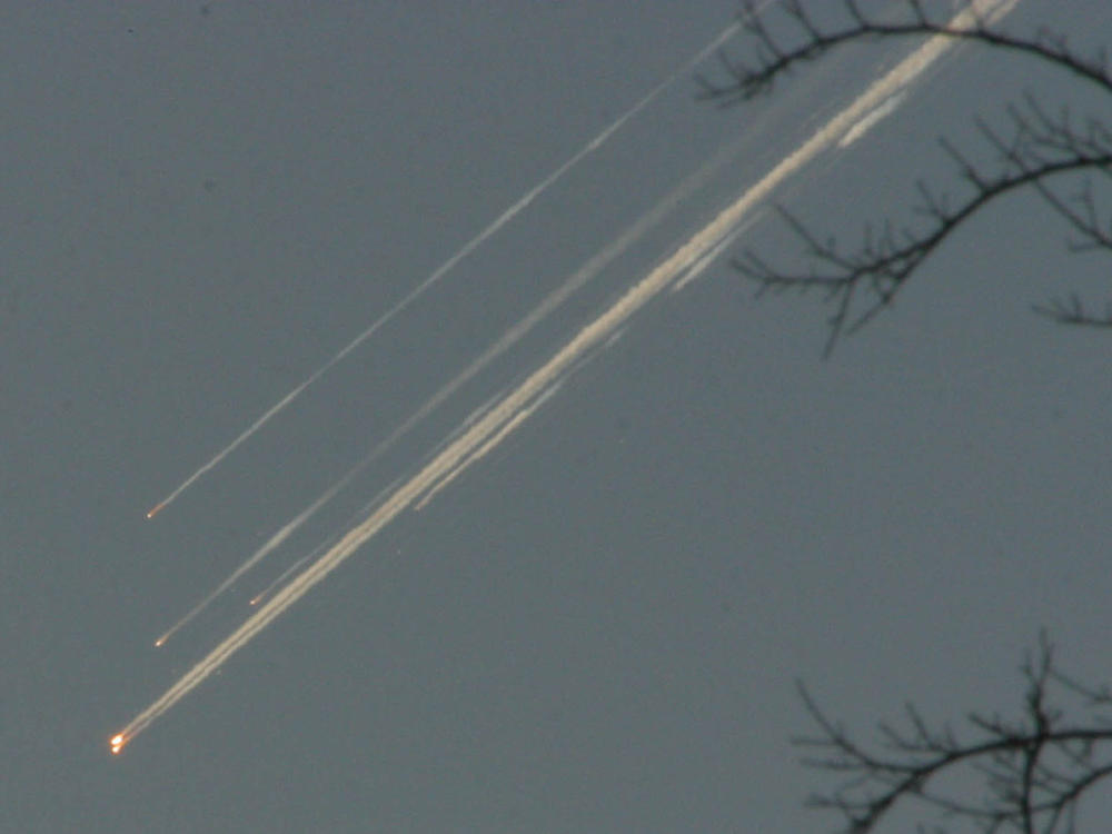 Debris from the space shuttle Columbia streaks across the Texas sky as seen from Dallas on Feb. 1, 2003.