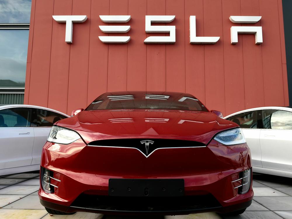 A Tesla car is displayed at a showroom and service center for the auto maker in Amsterdam on Oct. 23, 2019. Tesla recently cut prices across the board, a move with big potential ramifications for the automaker as well as for the industry.