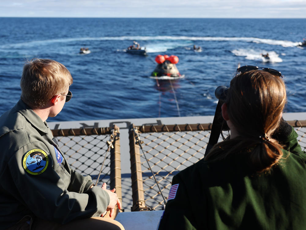 NASA recovery team members watch as NASA's Orion Capsule approaches after splashing down in the Pacific Ocean, west of Baja, Calif., following a successful uncrewed Artemis I Moon Mission on December 11, 2022.