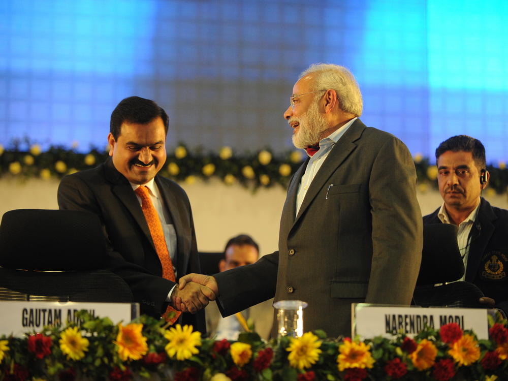Indian businessman Gautam Adani (left) shakes hands with Narendra Modi, the Gujarat chief minister at the time who would go on to become India's prime minister, at a summit on Jan. 13, 2011, in Gandhinagar, India.