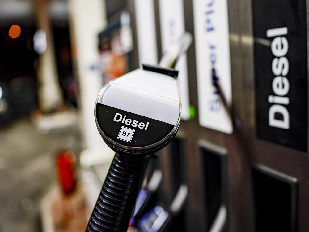 A pump nozzle at a gas station is labeled 