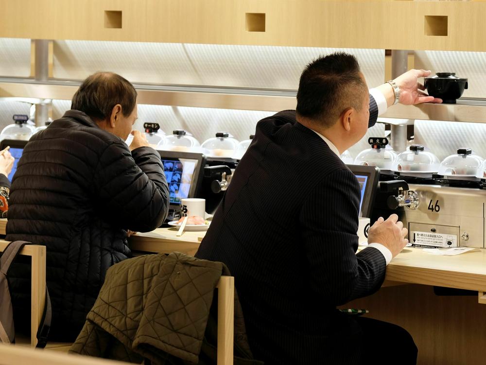 Customers dine at a Japanese conveyor belt sushi restaurant restaurant in Tokyo on Jan. 22, 2020.