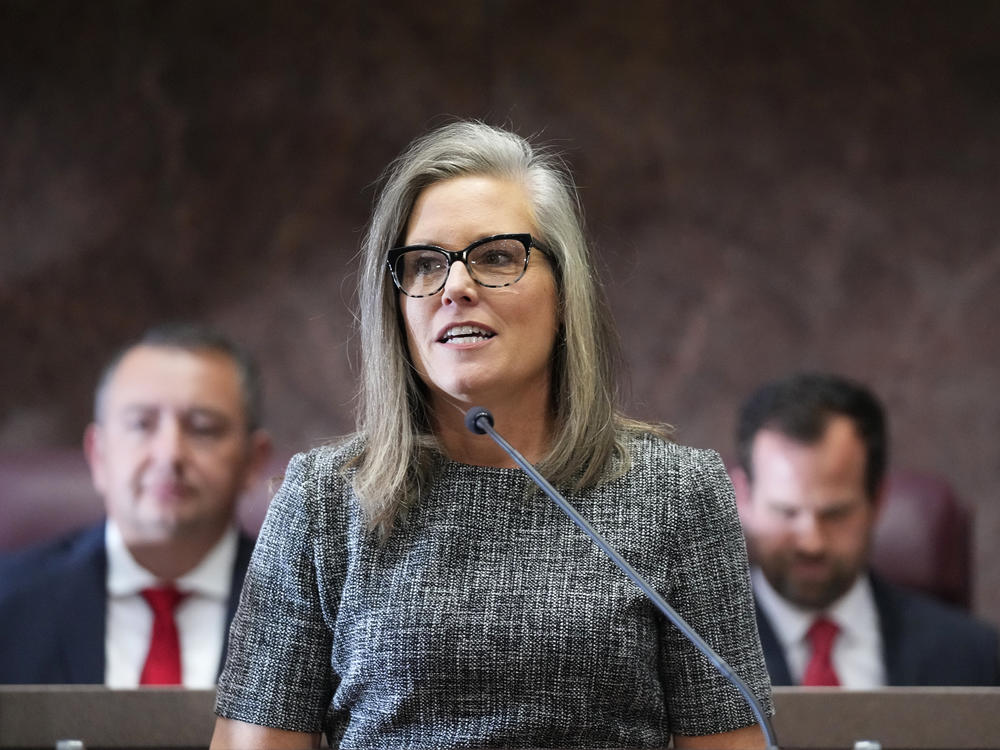 Democratic Arizona Gov. Katie Hobbs, middle, is flanked behind by Arizona House Speaker Ben Toma, left, and Arizona Senate President Warren Petersen, right, at Hobbs' state of the state address on Jan. 9, 2023, in Phoenix.