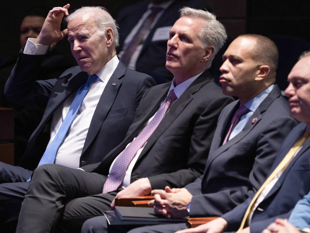 President Biden and Speaker Kevin McCarthy listen to a sermon as they sit together at the National Prayer Breakfast on Feb. 2.