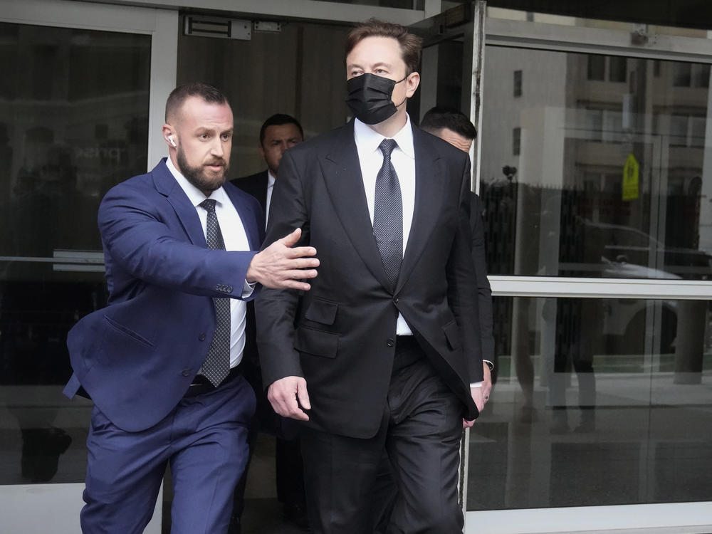 Elon Musk, center, leaves a federal courthouse in San Francisco on Feb. 3. A high-profile trial focused on a 2018 tweet about the financing for a Tesla buyout that never happened drew a surprise spectator for Friday's final arguments — Elon Musk, the billionaire who is being accused of misleading investors with his usage of the Twitter service he now owns.