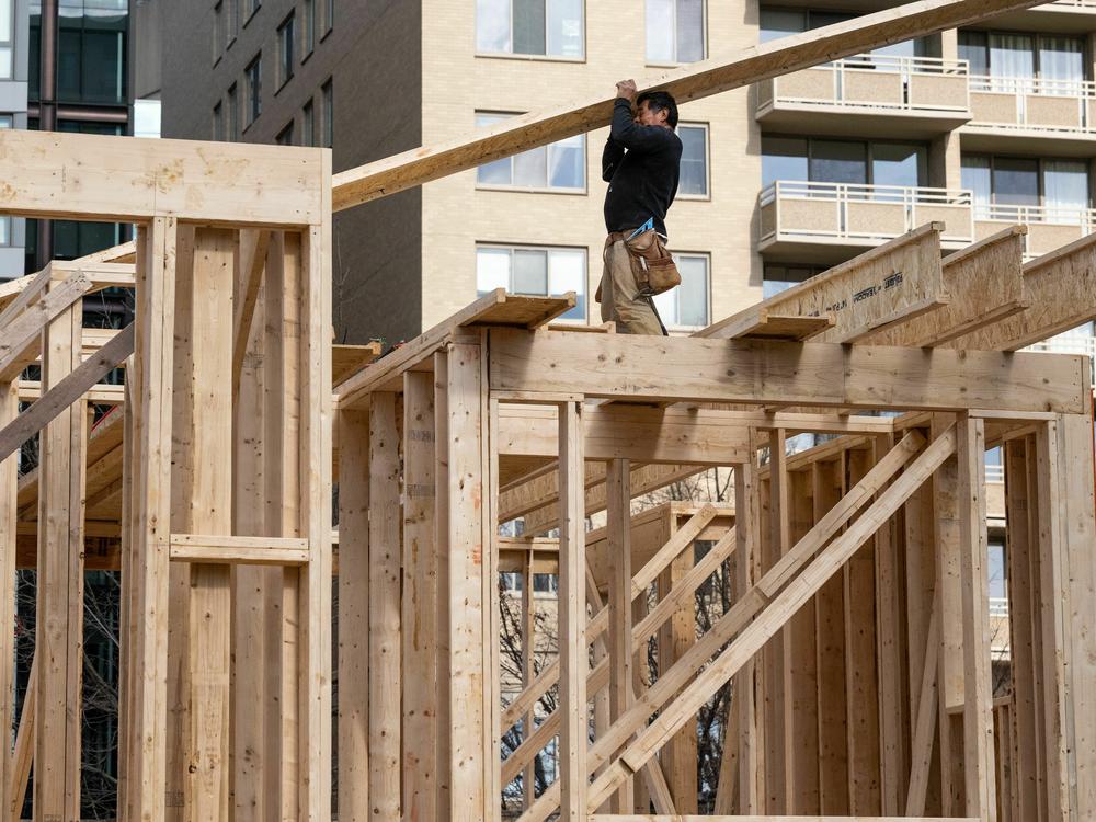 Construction workers build a residential house in Bethesda, Md., on Jan. 18, 2023. The housing sector has been hurt by the Fed's aggressive rate hikes, raising some concerns about the broader economy.