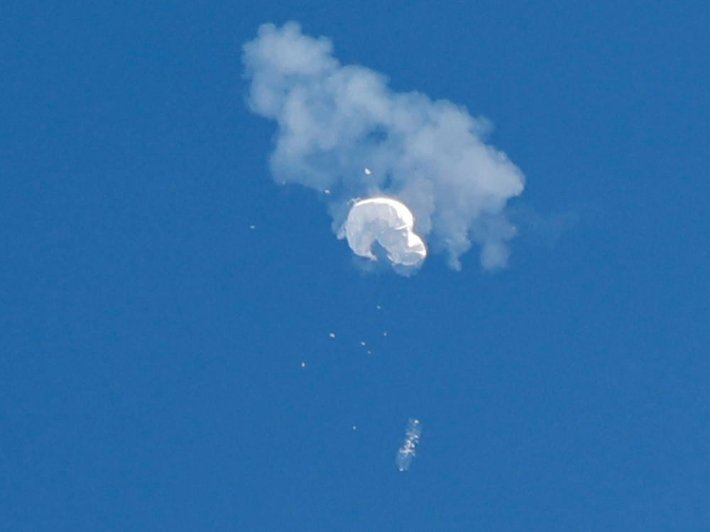 The suspected Chinese spy balloon drifts to the ocean after being shot down off the coast in Surfside Beach, S.C., on Saturday.